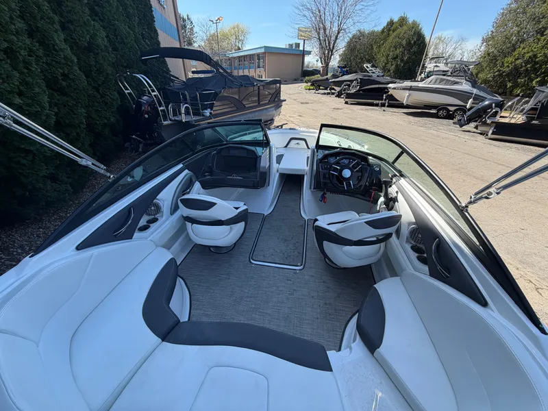 Slide: The Image of Interior of a 2019 Monterey 224FS boat, featuring modern seating and helm. - 19