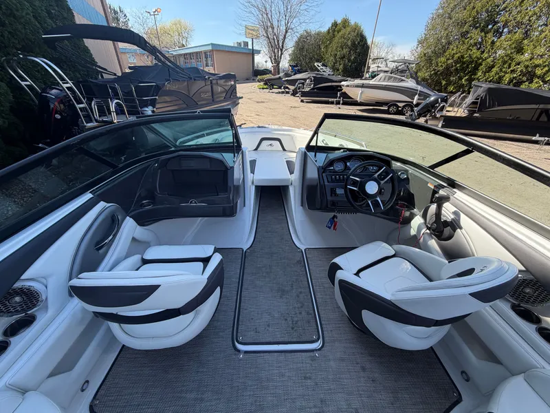 Slide: The Image of Interior of a 2019 Monterey 224FS boat, featuring modern seating and helm. - 20