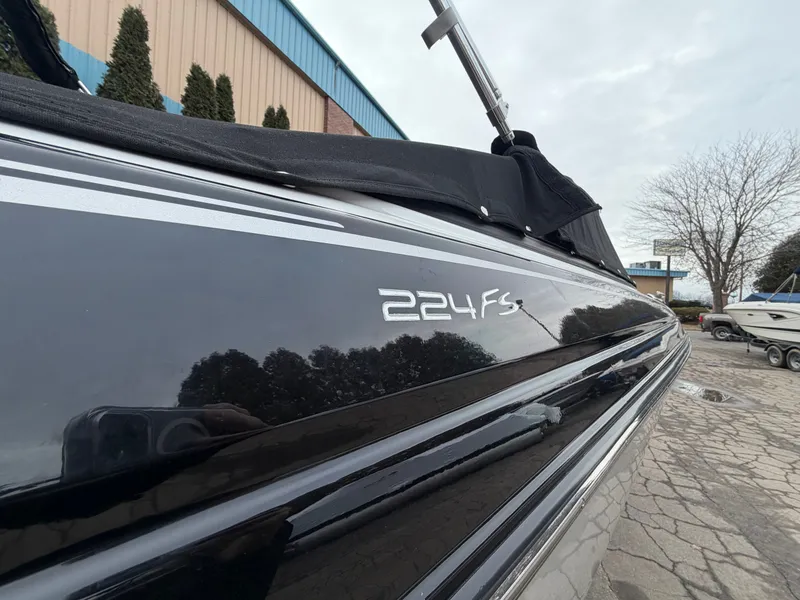 Slide: The Image of 2019 Monterey 224FS boat, black side view outdoors. - 3