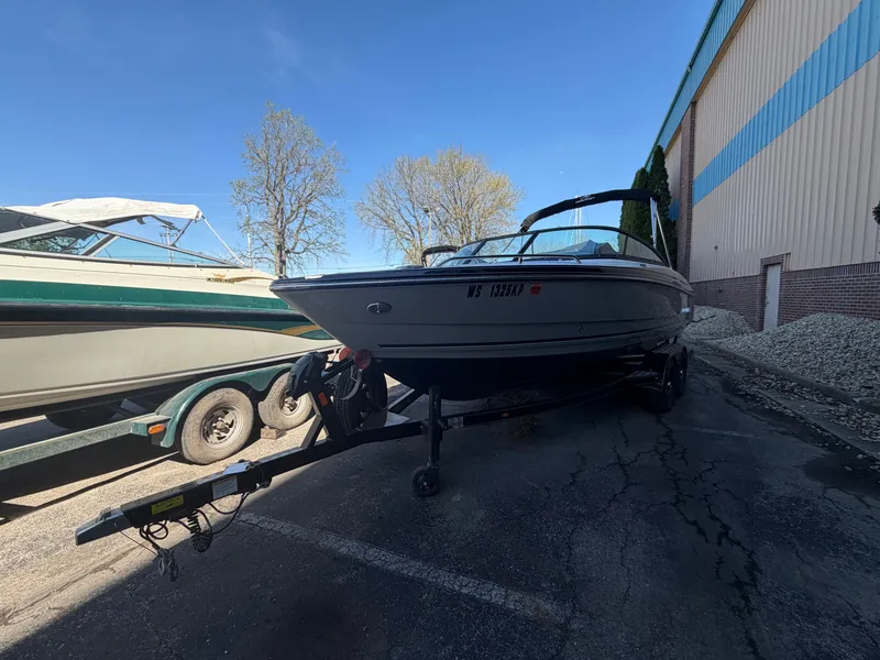 Slide: The Image of 2019 Monterey 224FS boat on trailer outside warehouse. - 45