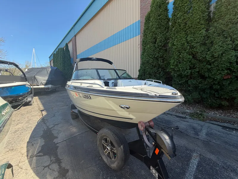 Slide: The Image of 2019 Monterey 224FS boat on trailer outside warehouse. - 46