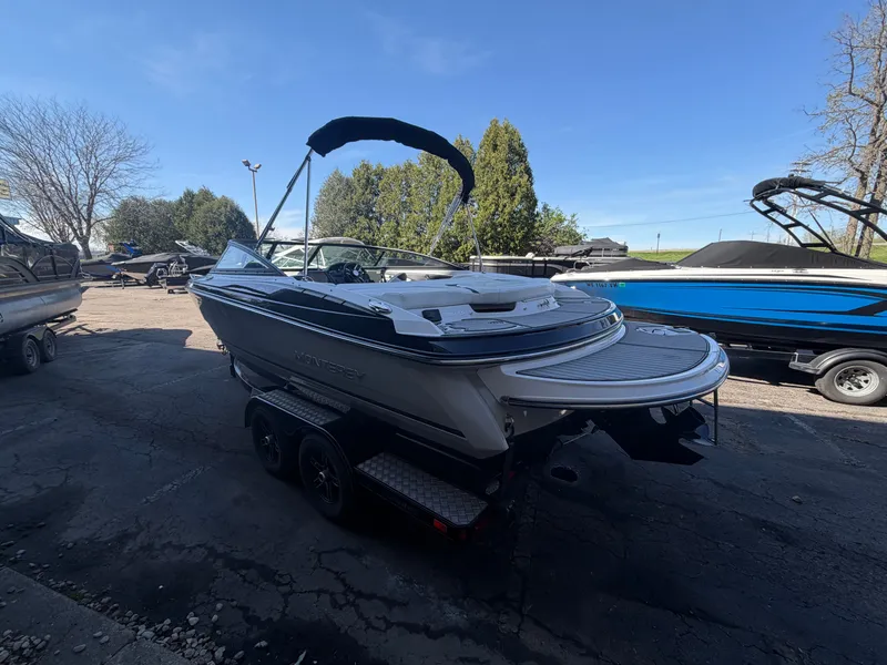 Slide: The Image of 2019 Monterey 224FS boat parked on trailer outdoors. - 49
