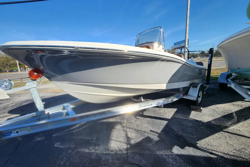 Slide: The Image of 2026 Pioneer 180 Islander boat on trailer, displayed outdoors under clear blue sky. - 11