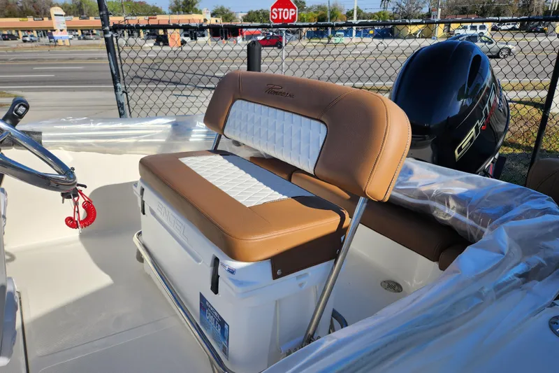 Slide: The Image of 2026 Pioneer 180 Islander boat interior with tan and white seating, steering wheel, and engine. - 5