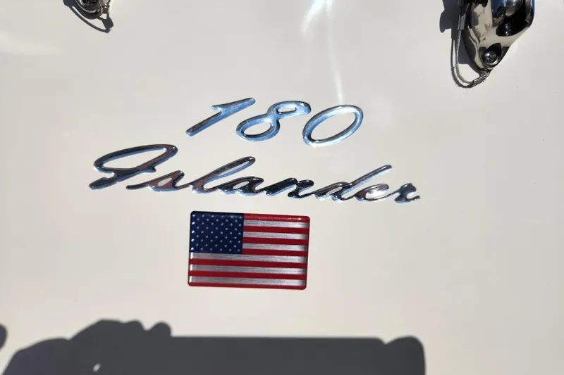 Slide: The Image of 2026 Pioneer 180 Islander boat emblem with American flag detail. - 7