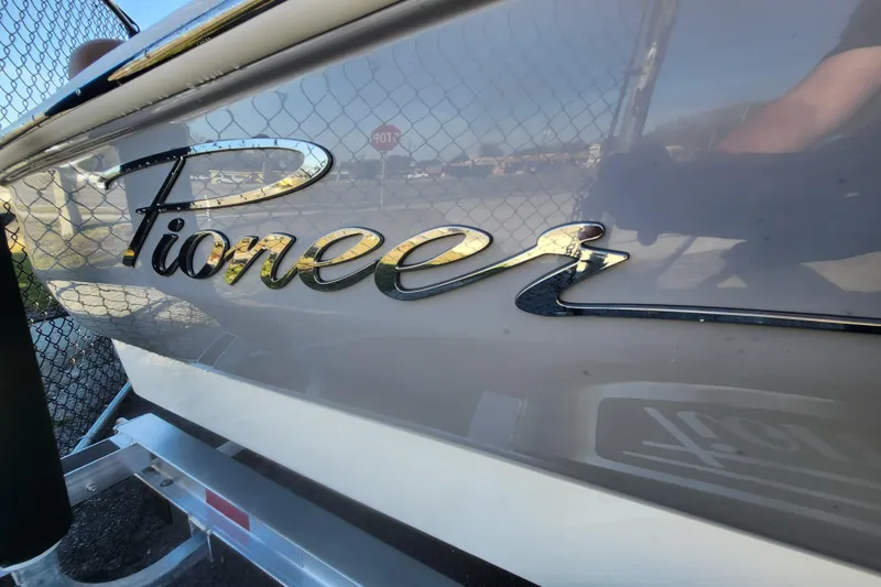 Slide: The Image of 2026 Pioneer 180 Islander boat logo on hull, close-up view. - 8