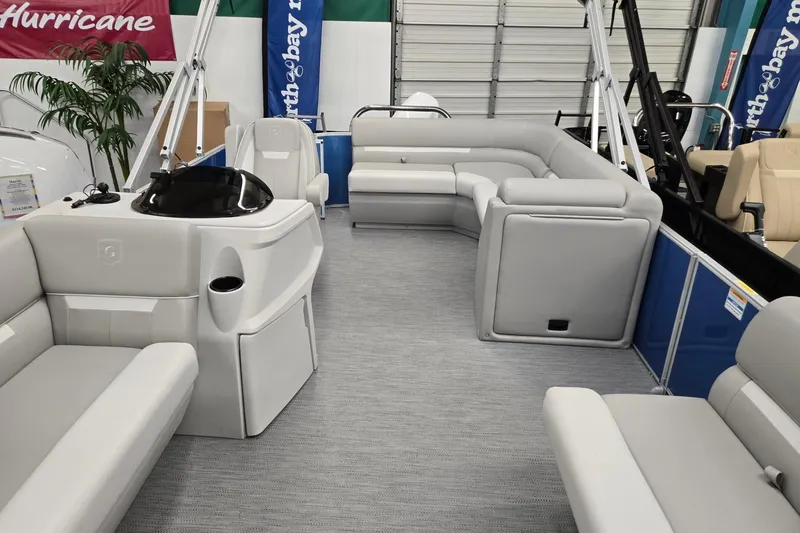 Slide: The Image of 2026 Godfrey EX 2086 CX pontoon boat interior with plush seating and modern helm. - 2