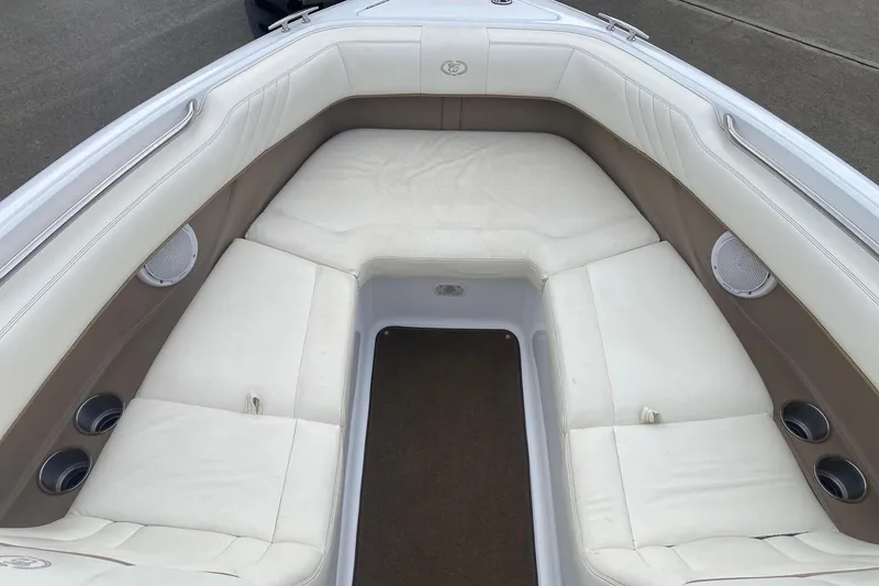 Slide: The Image of Interior of a 2008 Cobalt 222 boat with white cushioned seating. - 10