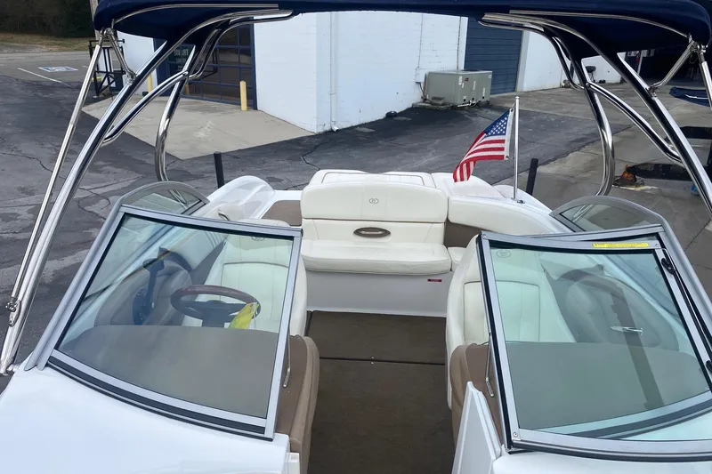 Slide: The Image of 2008 Cobalt 222 boat interior with American flag, featuring white seating and dual windshields. - 11