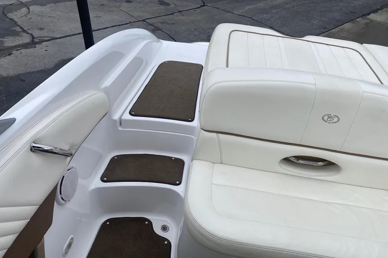 Slide: The Image of Interior of 2008 Cobalt 222 boat with white leather seating and brown carpeted steps. - 12