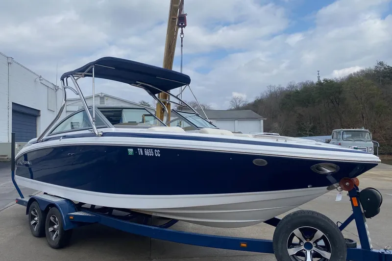 Slide: The Image of 2008 Cobalt 222 boat on trailer, blue and white, parked outdoors. - 3