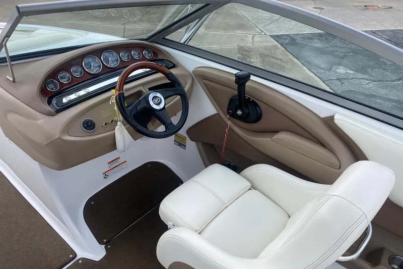 Slide: The Image of Interior of a 2008 Cobalt 222 boat with steering wheel and dashboard controls. - 8