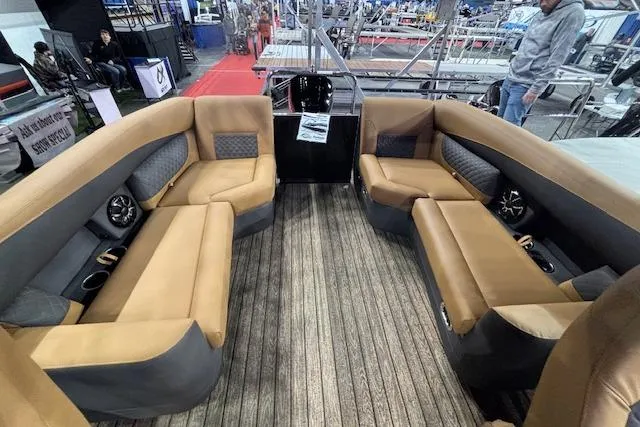 Slide: The Image of 2026 Harris Sunliner 230 boat interior with tan seating and wood-style flooring. - 11