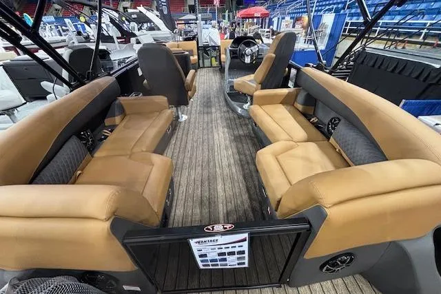 Slide: The Image of 2026 Harris Sunliner 230 pontoon boat interior with tan seating and wood-style flooring. - 12