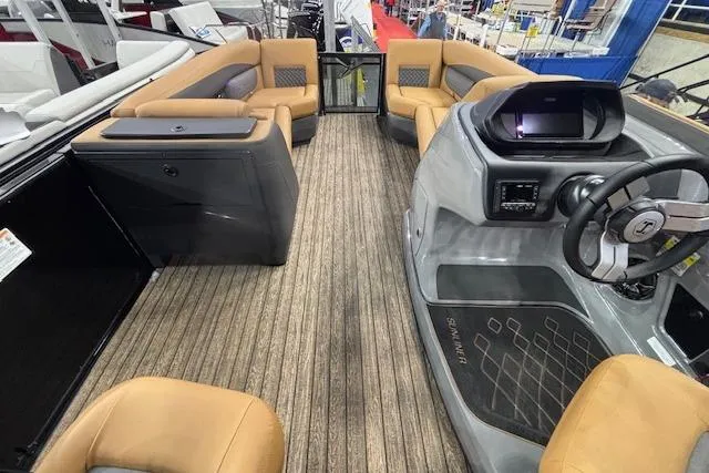 Slide: The Image of 2026 Harris Sunliner 230 boat interior with tan seating and modern dashboard. - 19
