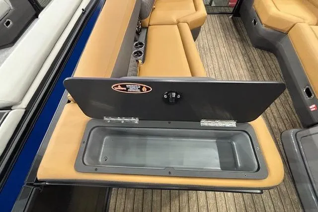 Slide: The Image of Interior seating and storage of 2026 Harris Sunliner 230 boat, featuring tan upholstery. - 21