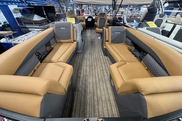Slide: The Image of Luxurious interior of 2026 Harris Sunliner 230 pontoon boat with tan seating. - 6