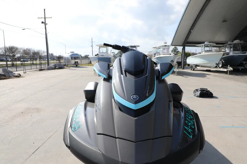 Slide: The Image of 2025 Yamaha WaveRunner FX HO jet ski in a marina setting, front view. - 16