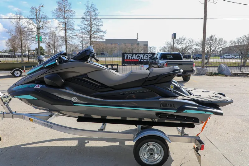 Slide: The Image of 2025 Yamaha WaveRunner FX HO on trailer, parked outdoors in a lot. - 2