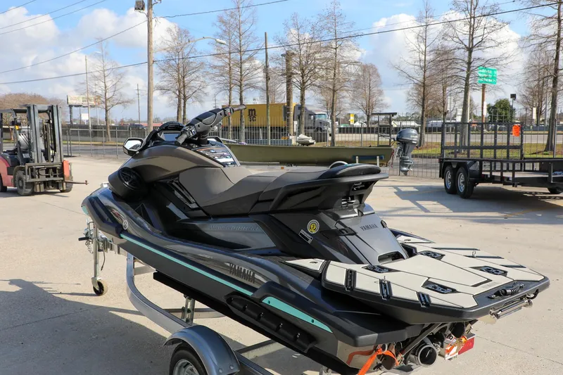 Slide: The Image of 2025 Yamaha WaveRunner FX HO jet ski on a trailer, parked outdoors. - 3