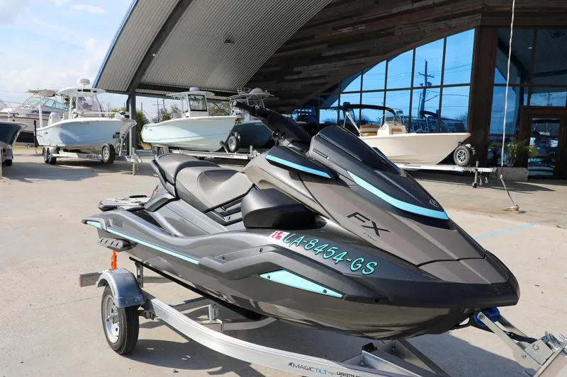 Slide: The Image of 2025 Yamaha WaveRunner FX HO jet ski on trailer, parked outside a showroom. - 6