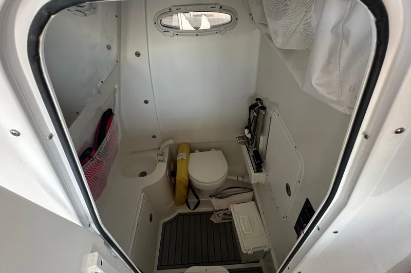 Slide: The Image of 2024 Sea Hunt Gamefish 30 boat interior with compact bathroom amenities. - 14
