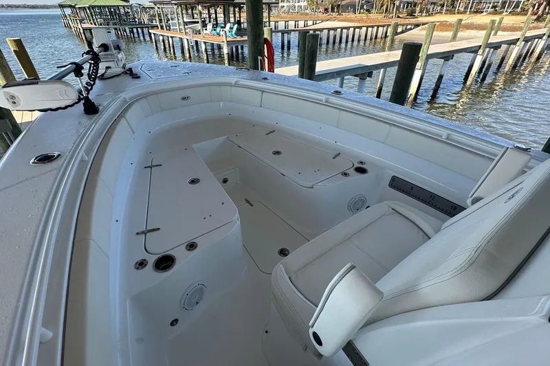 Slide: The Image of 2024 Sea Hunt Gamefish 30 Forward Seating boat interior with white cushioned seats. - 15