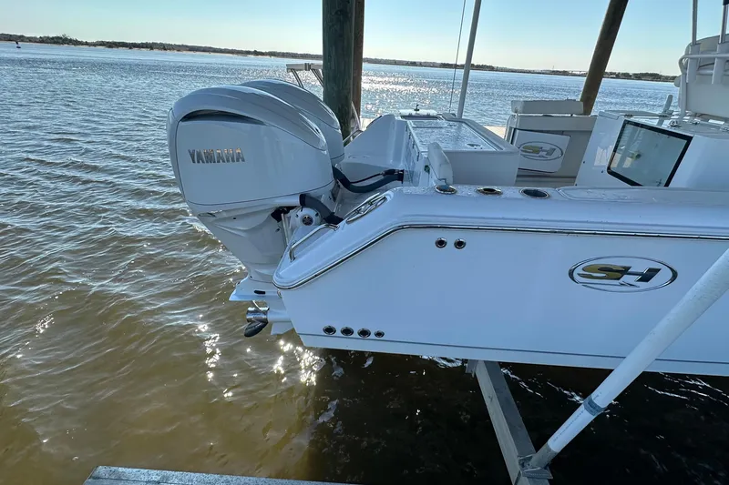 Slide: The Image of 2024 Sea Hunt Gamefish 30 with Yamaha engine, docked on a sunny day. - 6