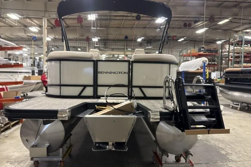 Slide: The Image of 2026 Bennington 22 SSRSE pontoon boat in a factory setting, rear view. - 6