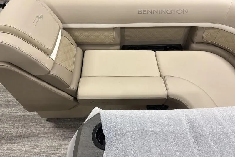 Slide: The Image of 2026 Bennington 22 SSRSE boat interior with beige cushioned seating and cup holder. - 7