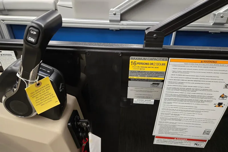 Slide: The Image of Control panel of 2026 Godfrey EX 2286 SFLX boat with capacity and safety warnings. - 11