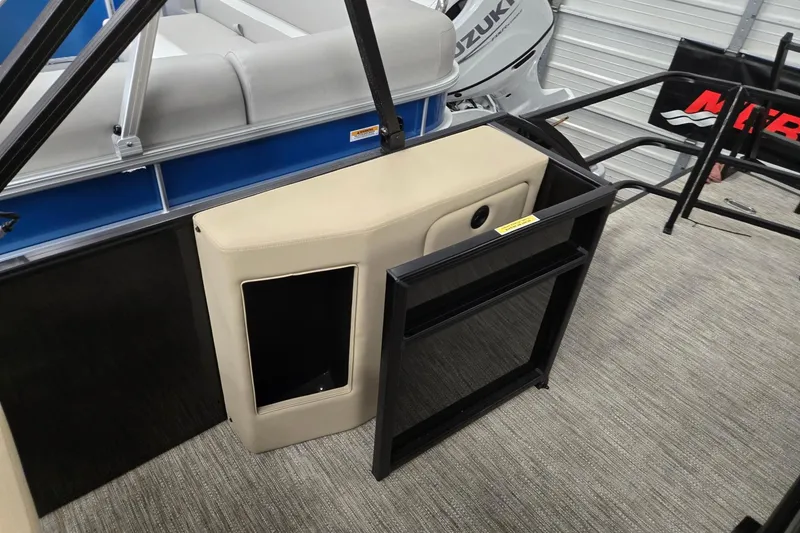 Slide: The Image of 2026 Godfrey EX 2286 SFLX boat interior with Suzuki engine, beige seating, and storage compartment. - 12