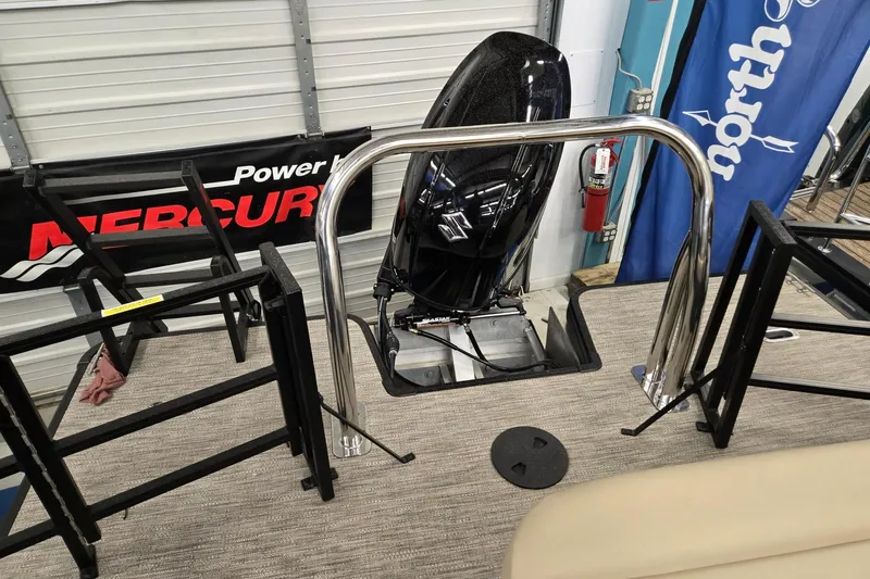 Slide: The Image of 2026 Godfrey EX 2286 SFLX boat with Mercury engine in showroom display. - 14