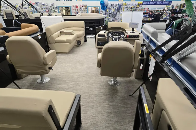 Slide: The Image of Interior of 2026 Godfrey EX 2286 SFLX pontoon boat with beige seating and steering console. - 16