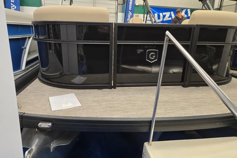 Slide: The Image of 2026 Godfrey EX 2286 SFLX pontoon boat with beige seating and black exterior. - 2
