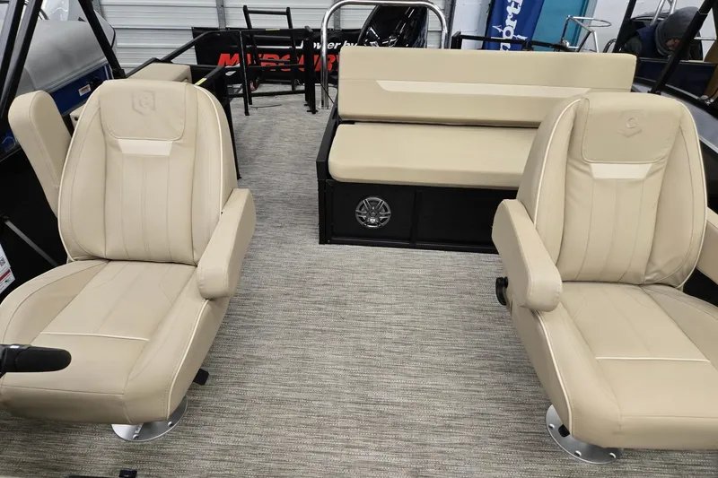 Slide: The Image of 2026 Godfrey EX 2286 SFLX boat interior with beige seating and carpeted flooring. - 6