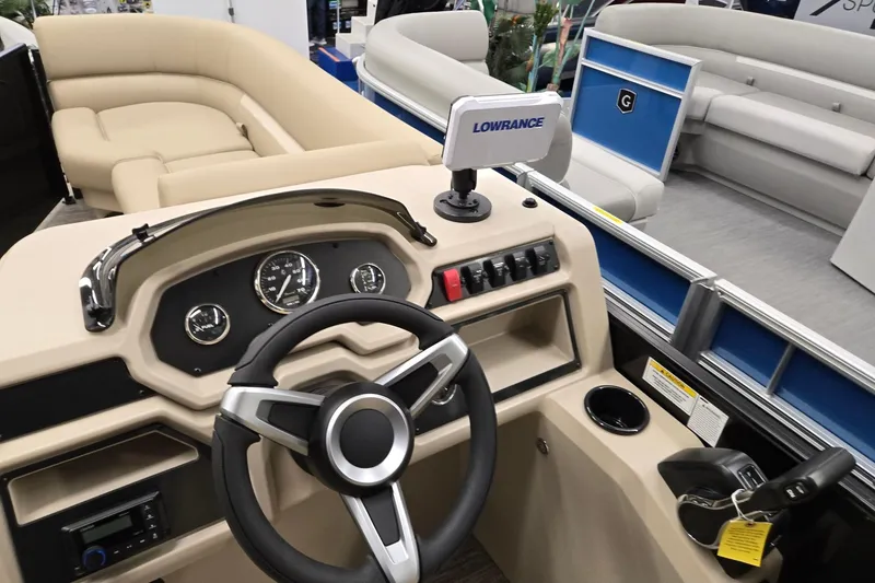 Slide: The Image of 2026 Godfrey EX 2286 SFLX boat interior with steering wheel and dashboard controls. - 9
