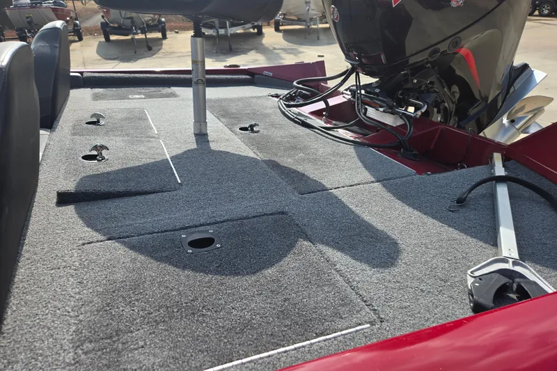 Slide: The Image of 2021 Tracker Pro Team 195 TXW boat interior with carpeted deck and motor. - 11