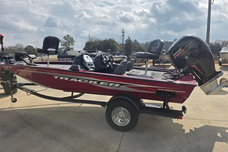 Slide: The Image of 2021 Tracker Pro Team 195 TXW fishing boat on trailer, parked outdoors. - 2