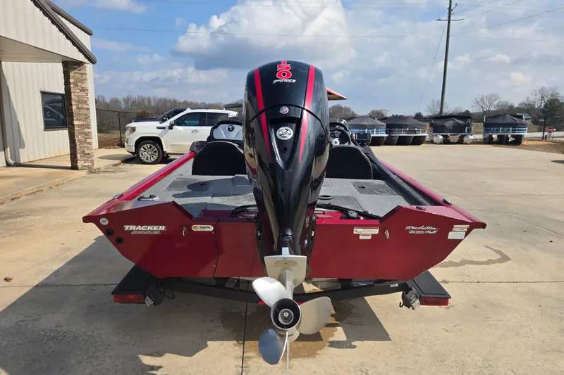 Slide: The Image of 2021 Tracker Pro Team 195 TXW boat with outboard motor, parked outdoors. - 4