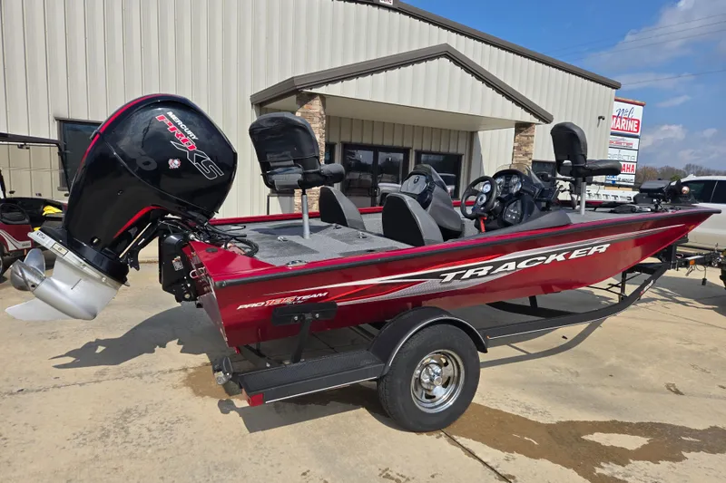 Slide: The Image of 2021 Tracker Pro Team 195 TXW boat with Mercury engine, parked outside a marine dealership. - 6