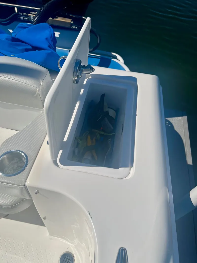 Slide: The Image of Open storage compartment on a 2006 Concept 27 boat. - 18