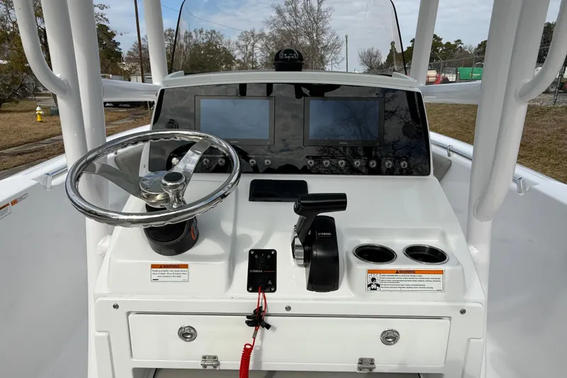 Slide: The Image of 2023 Sportsman Open 232 Center Console dashboard with steering wheel and controls. - 10