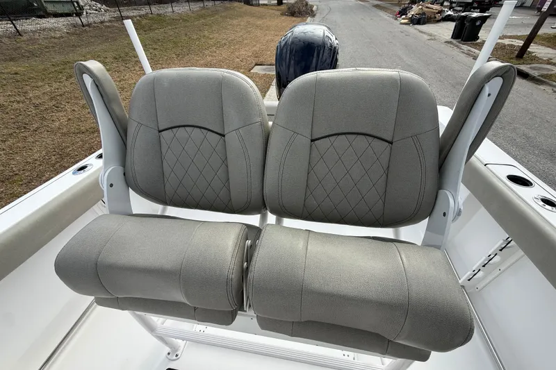 Slide: The Image of 2023 Sportsman Open 232 Center Console boat seats with gray upholstery and diamond stitching. - 12