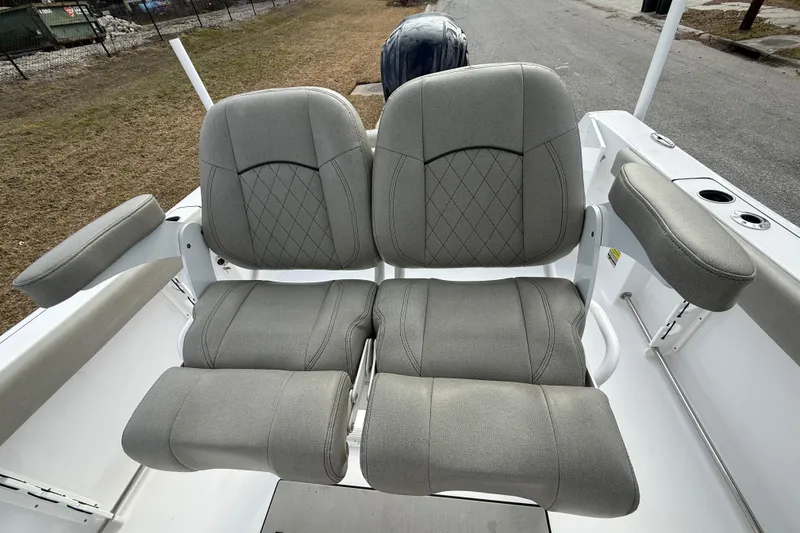 Slide: The Image of 2023 Sportsman Open 232 Center Console boat seats with gray upholstery and armrests. - 13