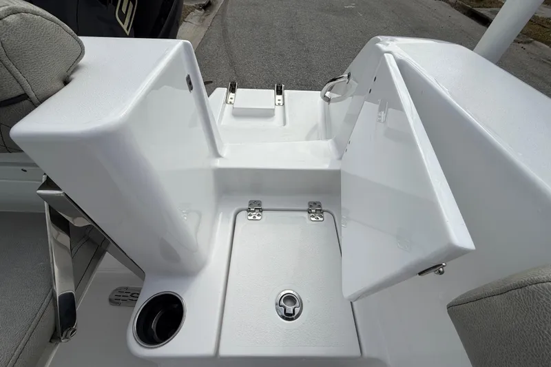 Slide: The Image of 2023 Sportsman Open 232 Center Console boat interior with storage compartment and cup holder. - 17