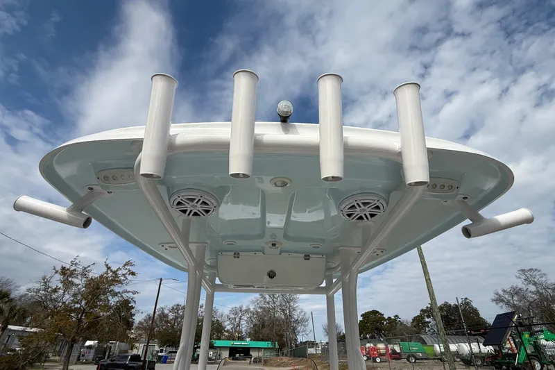 Slide: The Image of 2023 Sportsman Open 232 Center Console boat with rod holders and speakers, viewed from below. - 23