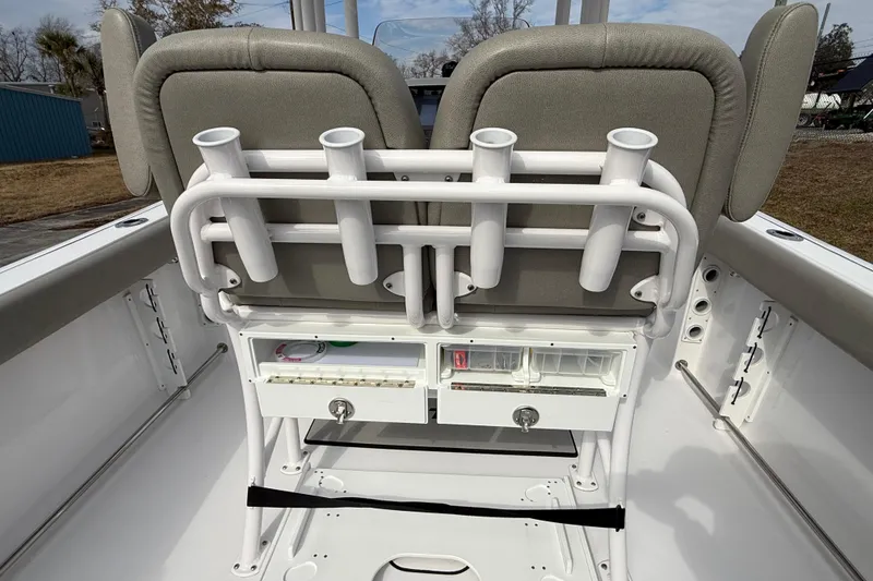 Slide: The Image of 2023 Sportsman Open 232 Center Console boat interior with rod holders and storage compartments. - 24