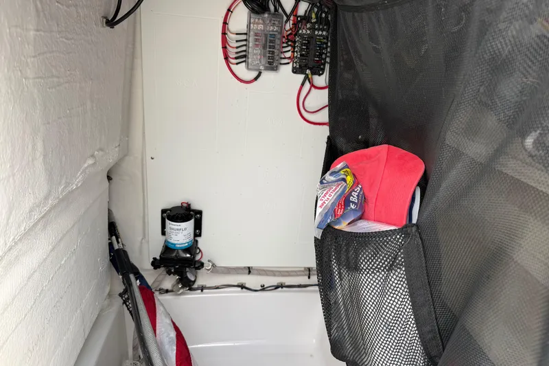 Slide: The Image of Interior of 2023 Sportsman Open 232 Center Console with storage and electrical components. - 27