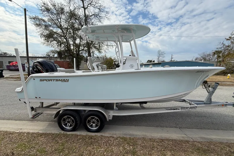 Slide: The Image of 2023 Sportsman Open 232 Center Console boat on trailer, parked outdoors. - 3